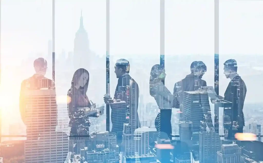 Business professionals in silhouette inside a modern office with Dubai city skyline in double exposure background.